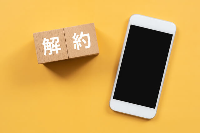 解約の札とスマホ